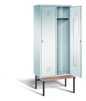 Ein lichtgrauer Garderobenschrank mit zwei Abteilen, zwei Fächern sowie integrierten Kleiderstangen mit Kleiderhaken, dessen rechte Tür geöffnet ist. Er steht auf einer unter- und vorgebauten Sitzbank vor weißem Hintergrund.