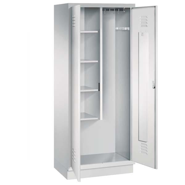 Ein lichtgrauer Putzmittelschrank mit zwei Abteilen, sowie einer integrierten Kleiderstange mit Kleiderhaken. Die beiden Türen sind geöffnet, im linken Abteil befinden sich vier Fachböden. Er steht auf einem Stahlblechsockel vor weißem Hintergrund.