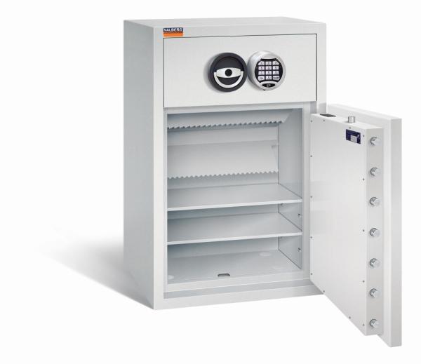 Ein lichtgrauer Deposittresor dessen Tür geöffnet ist. Im Türinnenraum befinden sich eine sichtbare Türverriegelung und Zertifikate. Der Innenraum ist leer und verfügt über zwei Fachböden. Der Tresor steht vor einem weißen Hintergrund